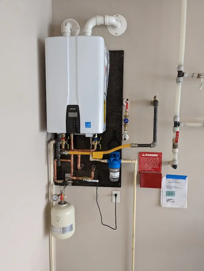 Professional plumber installing copper piping in a Lambertville home